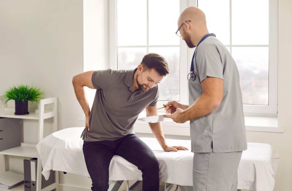Orthopaedic specialist with patient discussing low back pain symptoms
