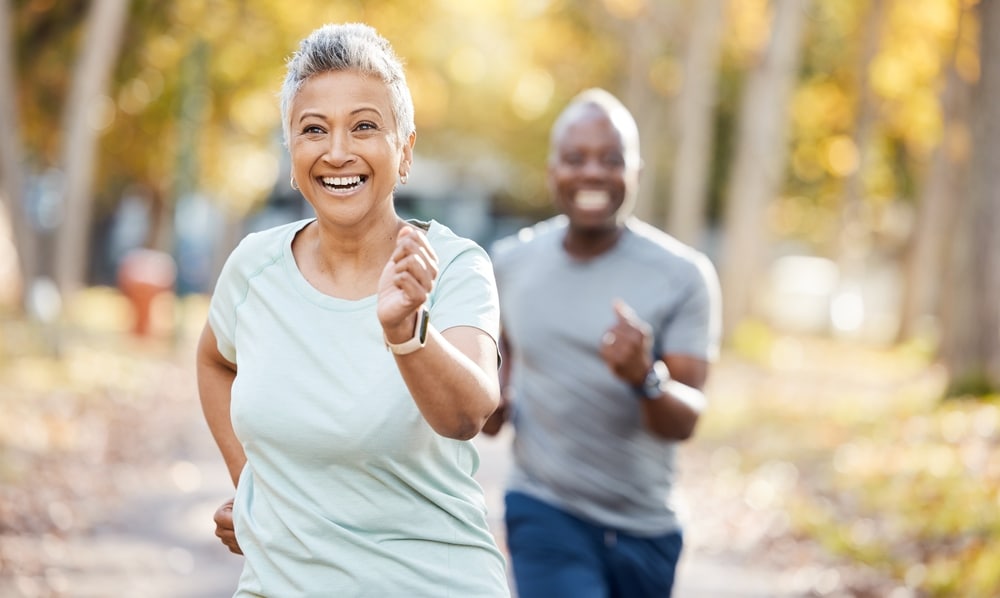 Older adults jogging outdoors to support strength, mobility, and aging joint health.